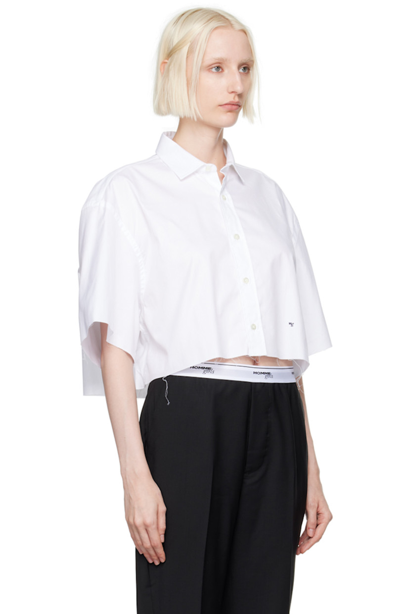 Oversized cotton twill shirt.

· Spread collar
· Button closure
· Logo embroidered at front
· Raw edge at cropped hem and cuffs
· Box pleat at back yoke

Supplier color: White