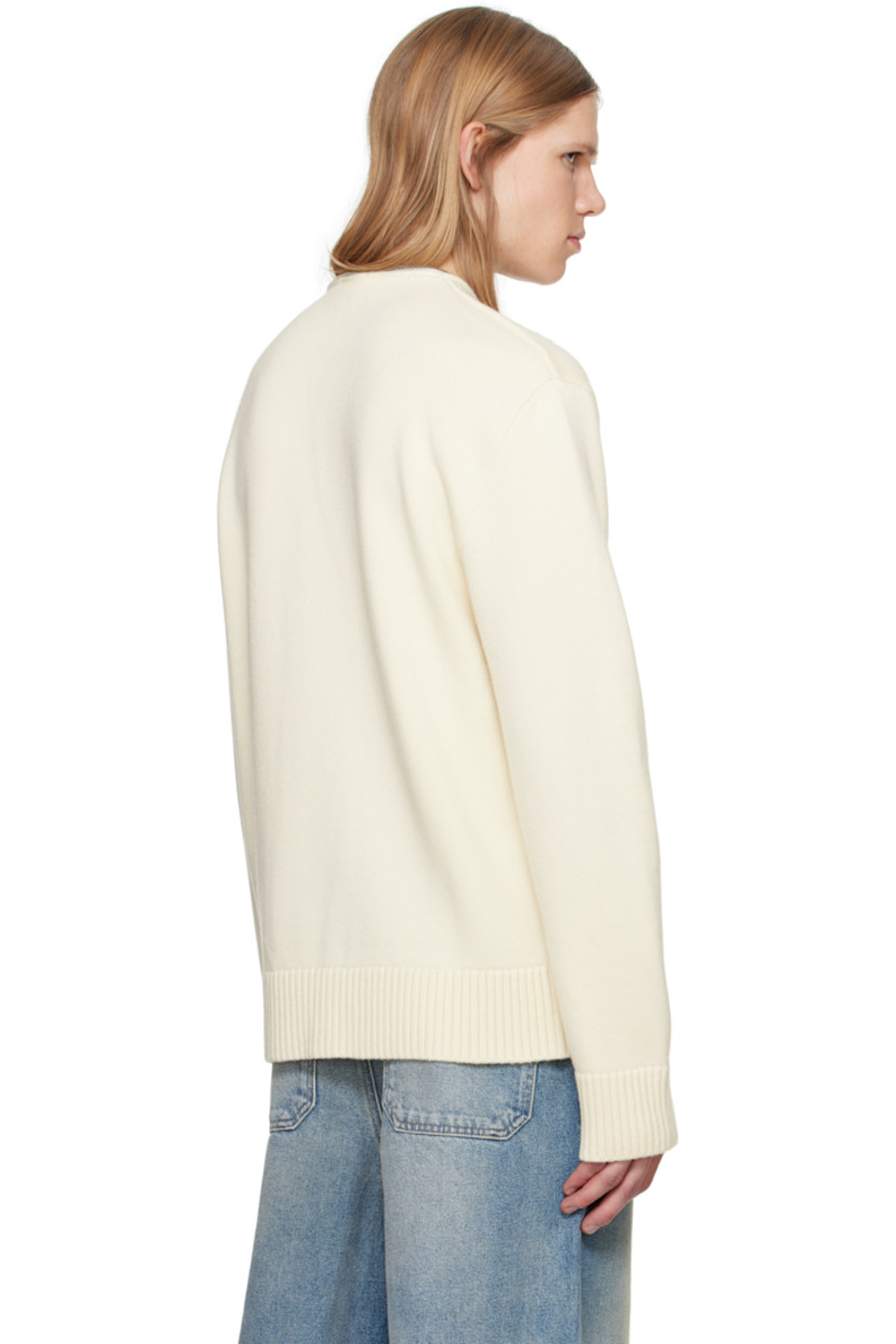 Knit merino wool sweater. 

· V-neck 
· Zip closure at collar
· Embroidered logo patch at chest 
· Rib-knit hem and cuffs
· Silver-tone hardware 

Supplier color: Natural beige