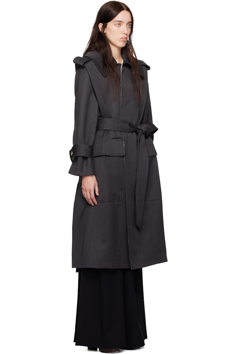Wool gabardine trench coat.

· Fold-down collar
· Detachable buttoned throat guard
· Self-tie belt at waist
· Flap pockets at front
· Epaulets
· Integrated belt at cuffs
· Vented at side seam and back
· Storm flap
· Partial satin lining

Supplier color: Charcoal