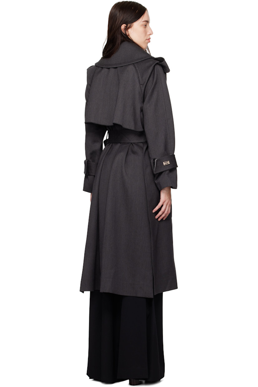 Wool gabardine trench coat.

· Fold-down collar
· Detachable buttoned throat guard
· Self-tie belt at waist
· Flap pockets at front
· Epaulets
· Integrated belt at cuffs
· Vented at side seam and back
· Storm flap
· Partial satin lining

Supplier color: Charcoal