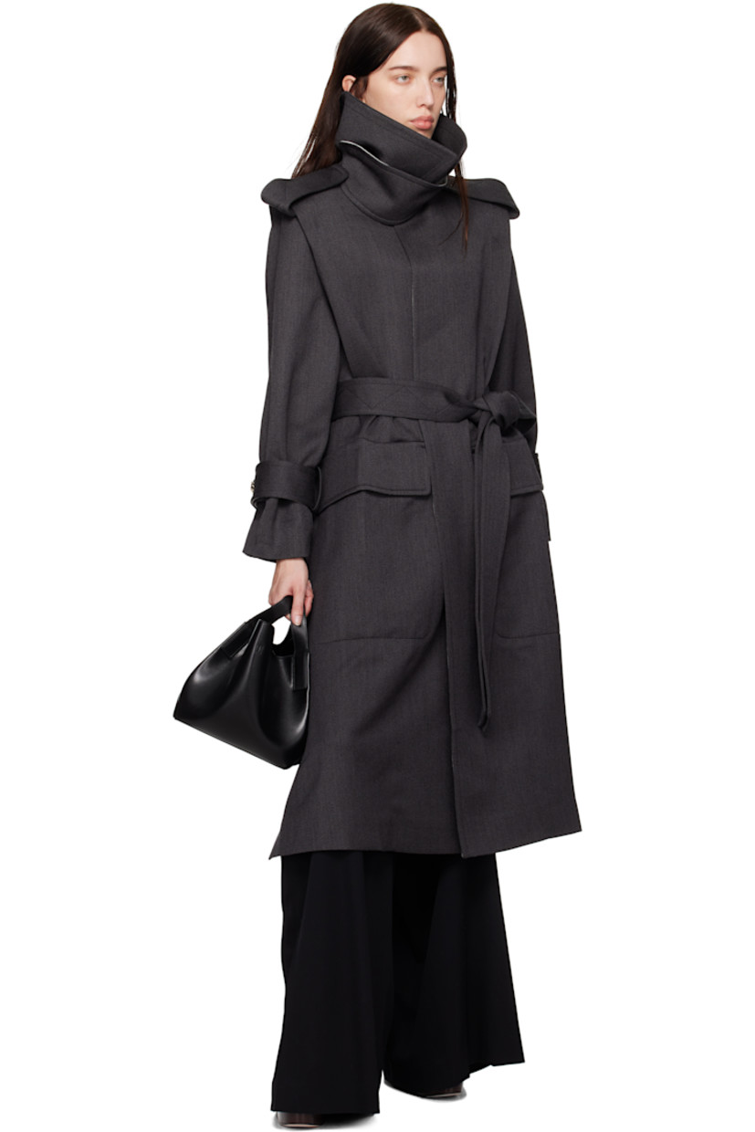 Wool gabardine trench coat.

· Fold-down collar
· Detachable buttoned throat guard
· Self-tie belt at waist
· Flap pockets at front
· Epaulets
· Integrated belt at cuffs
· Vented at side seam and back
· Storm flap
· Partial satin lining

Supplier color: Charcoal