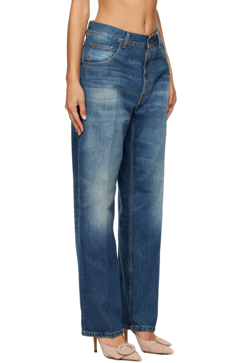 Non-stretch denim jeans. Fading, whiskering, and subtle distressing throughout. 

· Belt loops
· Five-pocket styling
· Zip-fly 
· Creased legs
· Leather logo patch at back waistband
· Logo-engraved antiqued bronze-tone hardware
· Contrast stitching in tan

Supplier color: Heavy vintage med wash