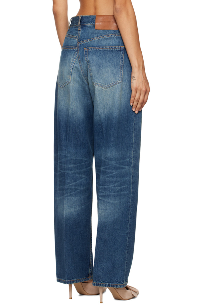 Non-stretch denim jeans. Fading, whiskering, and subtle distressing throughout. 

· Belt loops
· Five-pocket styling
· Zip-fly 
· Creased legs
· Leather logo patch at back waistband
· Logo-engraved antiqued bronze-tone hardware
· Contrast stitching in tan

Supplier color: Heavy vintage med wash