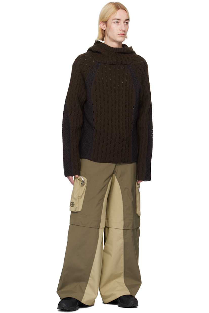 Loose-fit deadstock plain-woven stretch nylon cargo pants. Taped seams throughout.

· Water-resistant, breathable, and windproof
· Paneled construction
· Bungee-style drawstring at waistband and cuffs
· Four-pocket styling
· Zip fly
· Zip fastening at knees for shorts styling
· Zip bellows pocket at outseams
· Rubber logo patches at outseam

Part of the Charlie Constantinou x 66°North collaboration.

Supplier color: Earth