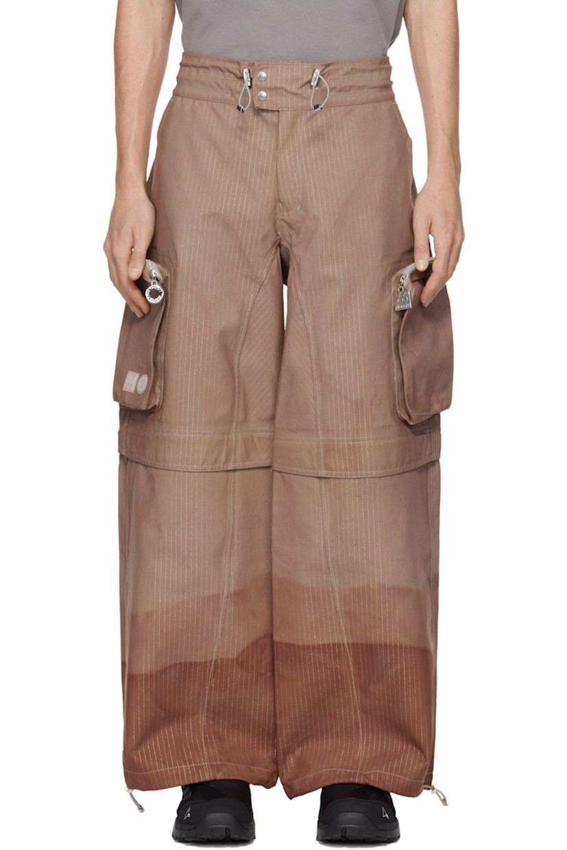 Hand-dyed deadstock plain-woven stretch nylon cargo pants. Reflective stripes and taped seams throughout.

· Bungee-style drawstring at waistband and cuffs
· Four-pocket styling
· Zip fly
· Zip fastening at knees for shorts styling
· Zip bellows pocket at outseams
· Rubber logo patches at outseam

Each item is unique. Please note coloration may vary.

Part of the Charlie Constantinou x 66°North collaboration.

Available exclusively at SSENSE.

Supplier color: C725
