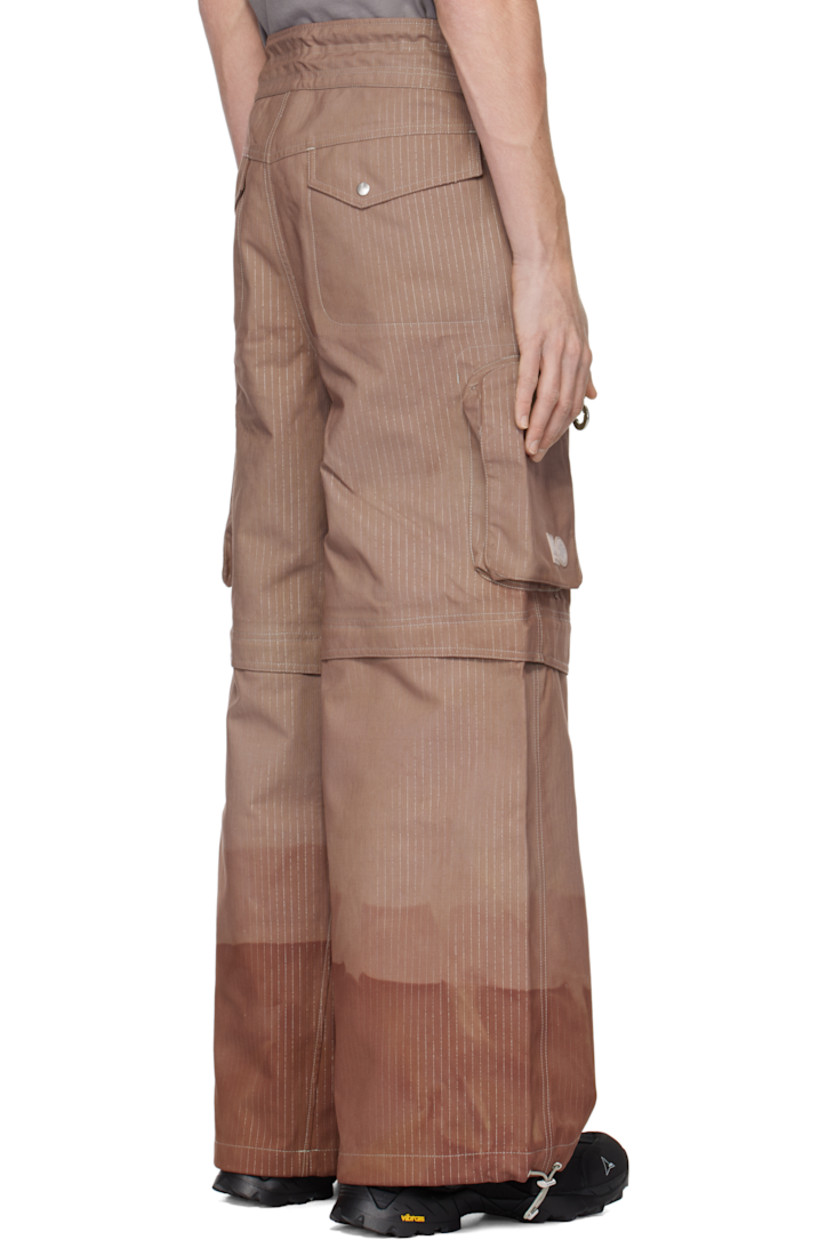 Hand-dyed deadstock plain-woven stretch nylon cargo pants. Reflective stripes and taped seams throughout.

· Bungee-style drawstring at waistband and cuffs
· Four-pocket styling
· Zip fly
· Zip fastening at knees for shorts styling
· Zip bellows pocket at outseams
· Rubber logo patches at outseam

Each item is unique. Please note coloration may vary.

Part of the Charlie Constantinou x 66°North collaboration.

Available exclusively at SSENSE.

Supplier color: C725