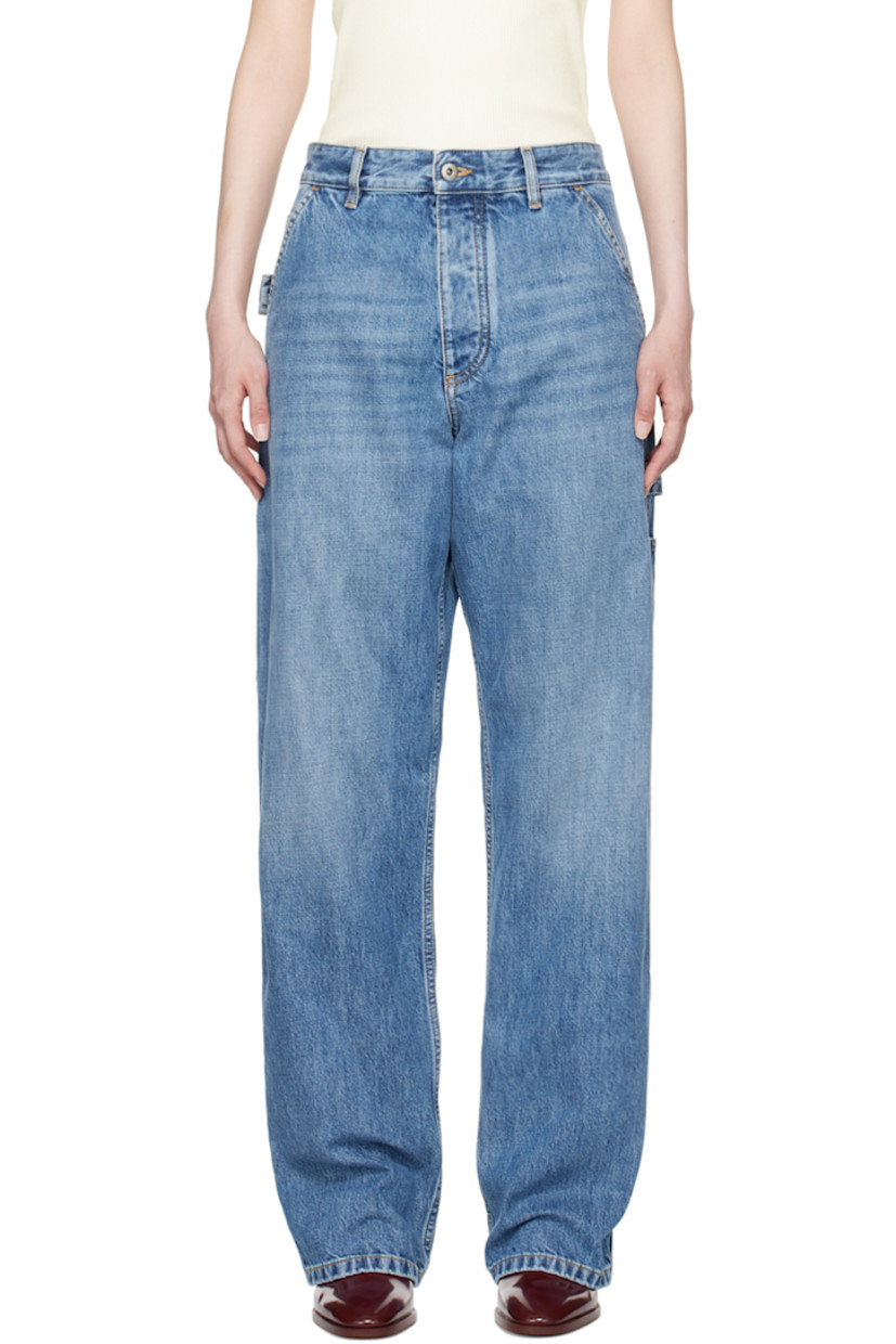 Non-stretch denim jeans. Fading and whiskering throughout. 

· Belt loops
· Five-pocket styling
· Button-fly
· Patch pockets at outseams
· Hammer loop at outseam and back pocket
· Logo patch at back waistband
· Contrast stitching in tan
 
Supplier color: Mid blue