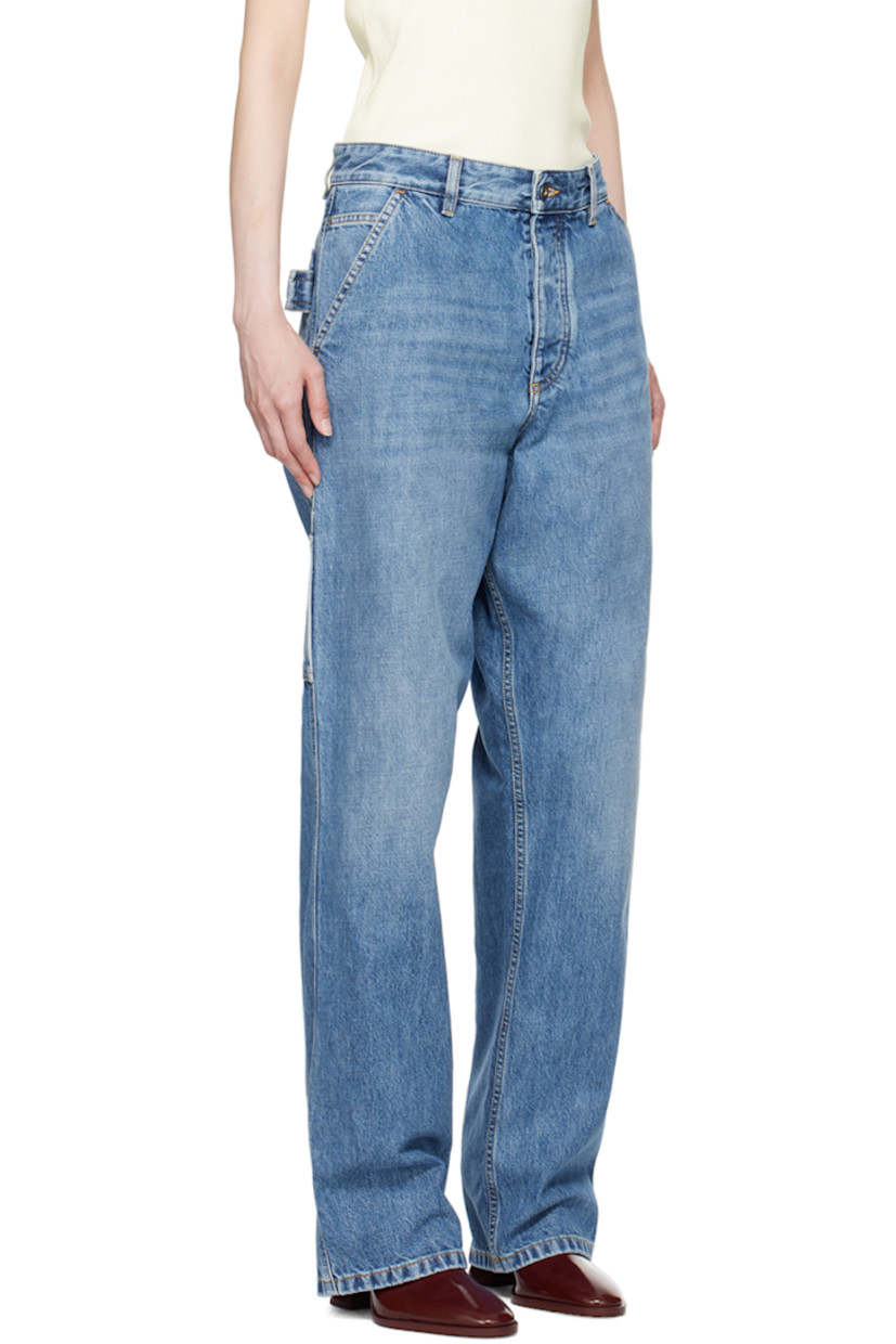 Non-stretch denim jeans. Fading and whiskering throughout. 

· Belt loops
· Five-pocket styling
· Button-fly
· Patch pockets at outseams
· Hammer loop at outseam and back pocket
· Logo patch at back waistband
· Contrast stitching in tan
 
Supplier color: Mid blue