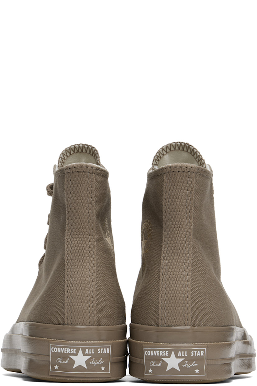 High-top canvas sneakers in taupe.

· Rubber cap toe
· Lace-up closure
· Logo stamp and eyelets at inner side
· Cushioned Ortholite® footbed
· Rubberized logo patch at heel
· Treaded rubber sole

Supplier color: Mud mask/Light gold