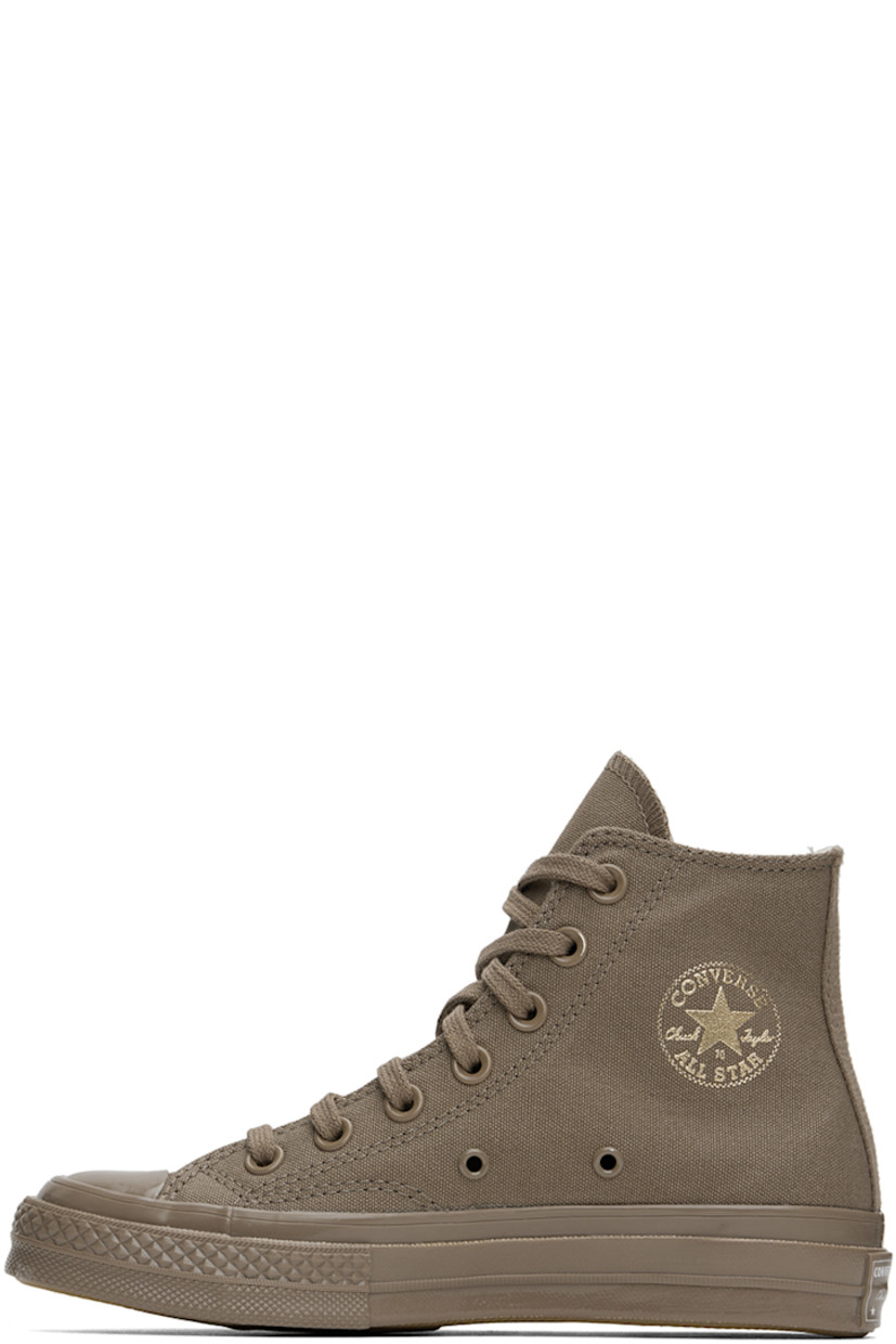 High-top canvas sneakers in taupe.

· Rubber cap toe
· Lace-up closure
· Logo stamp and eyelets at inner side
· Cushioned Ortholite® footbed
· Rubberized logo patch at heel
· Treaded rubber sole

Supplier color: Mud mask/Light gold