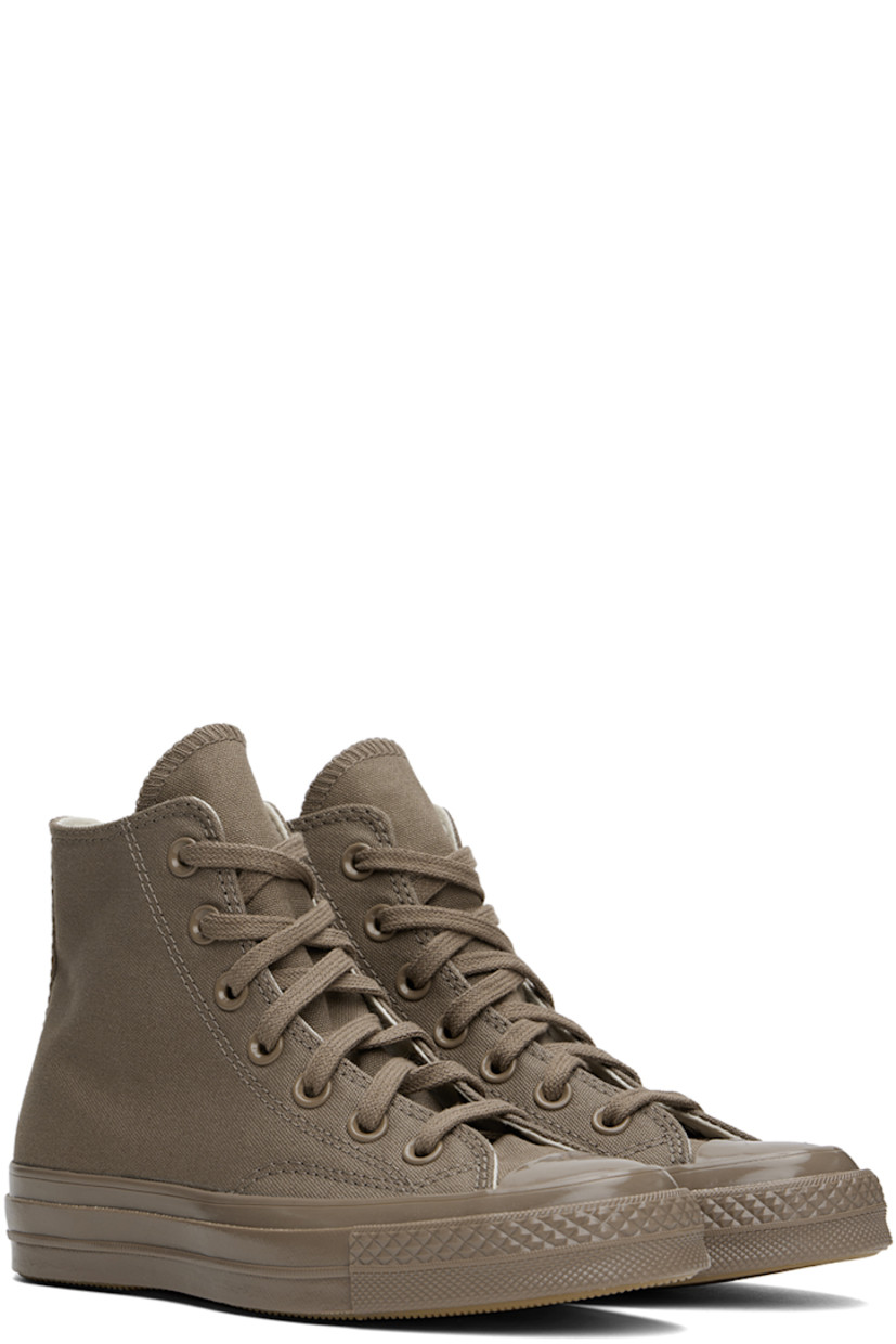 High-top canvas sneakers in taupe.

· Rubber cap toe
· Lace-up closure
· Logo stamp and eyelets at inner side
· Cushioned Ortholite® footbed
· Rubberized logo patch at heel
· Treaded rubber sole

Supplier color: Mud mask/Light gold
