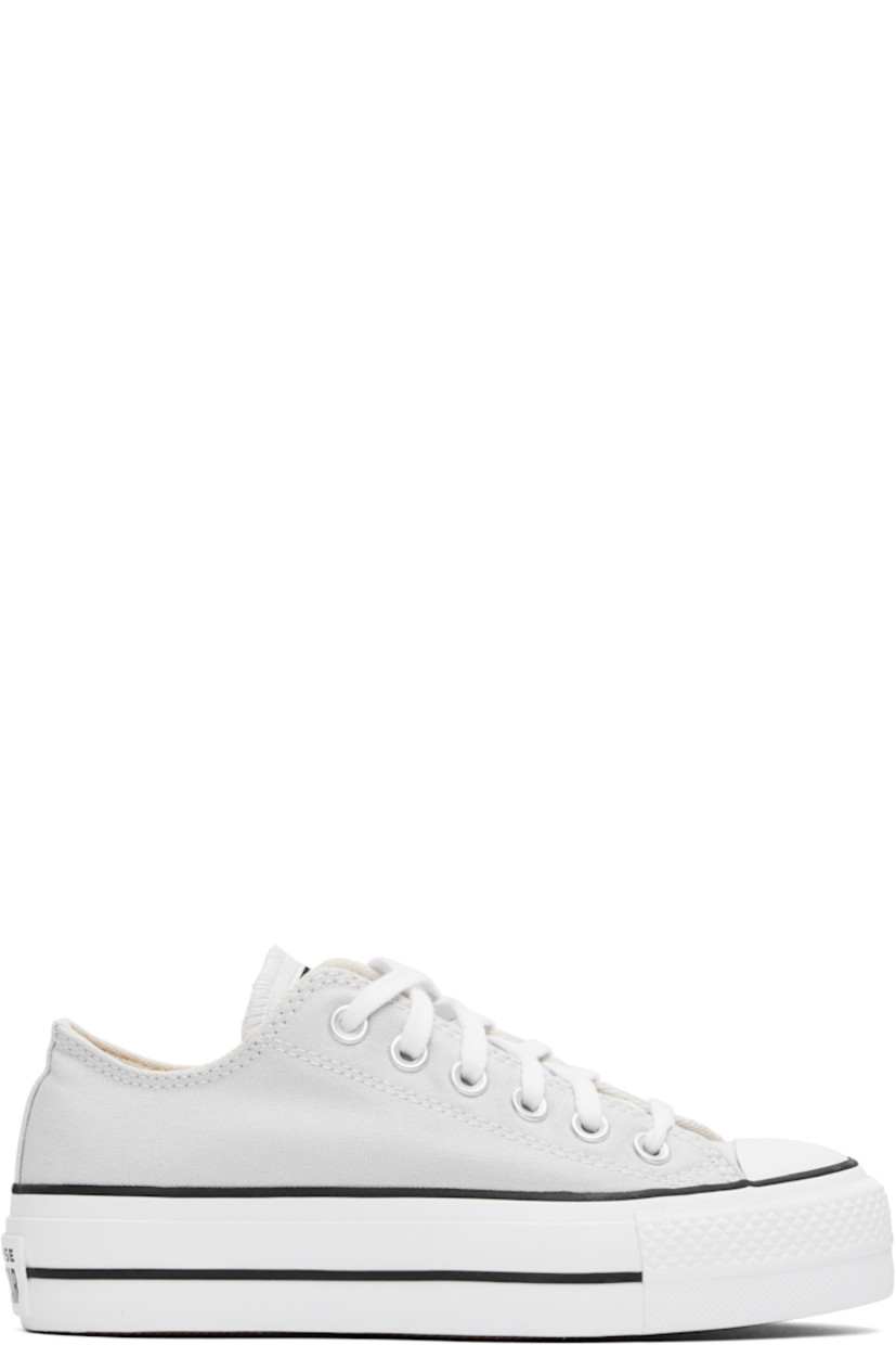 Low-top canvas sneakers in gray.

· Rubber cap toe
· Lace-up closure
· Mesh lining
· OrthoLite cushioning insole
· Logo patch at heel
· Treaded rubber platform sole
· Platform: H1.5"

Supplier color: Barely Grey/White/Black
