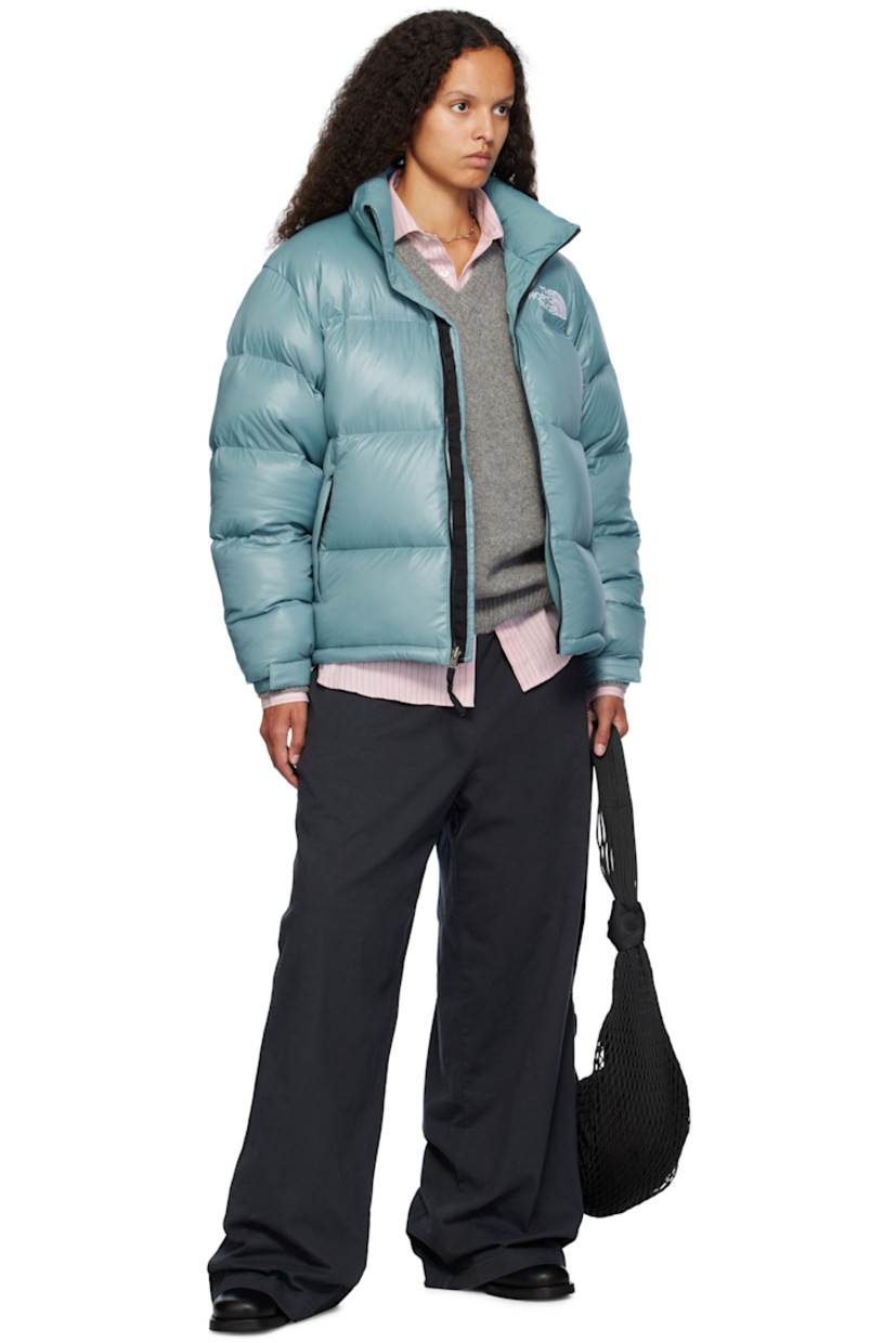RDS-certified down-filled and quilted non-PFC DWR-coated recycled nylon ripstop jacket. Windproof, water-repellent, and abrasion-resistant.

· Packable
· Stowaway hood at funnel neck
· Concealed bungee-style drawstring at hood and hem
· Zip closure
· Logo embroidered at chest and back
· Zip pockets
· Packs into zip pocket
· Text embroidered at sleeve
· Velcro fastening at elasticized cuffs
· Triclimate® press-stud fastening at cuffs
· Zip pocket at interior
· Full nylon taffeta lining

Available exclusively at SSENSE.

Supplier color: Algae blue shine

Fill: 85% down, 15% waterfowl feathers.