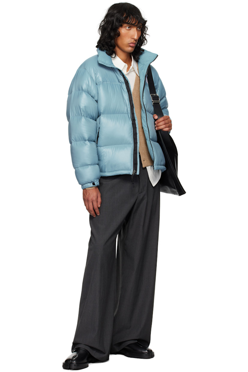 RDS-certified down-filled and quilted non-PFC DWR-coated recycled nylon ripstop jacket. Windproof, water-repellent, and abrasion-resistant.

· Packable
· Stowaway hood at funnel neck
· Concealed bungee-style drawstring at hood and hem
· Zip closure
· Logo embroidered at chest and back
· Zip pockets
· Packs into zip pocket
· Text embroidered at sleeve
· Velcro fastening at elasticized cuffs
· Triclimate® press-stud fastening at cuffs
· Zip pocket at interior
· Full nylon taffeta lining

Available exclusively at SSENSE.

Supplier color: Algae blue shine

Fill: 85% down, 15% waterfowl feathers.