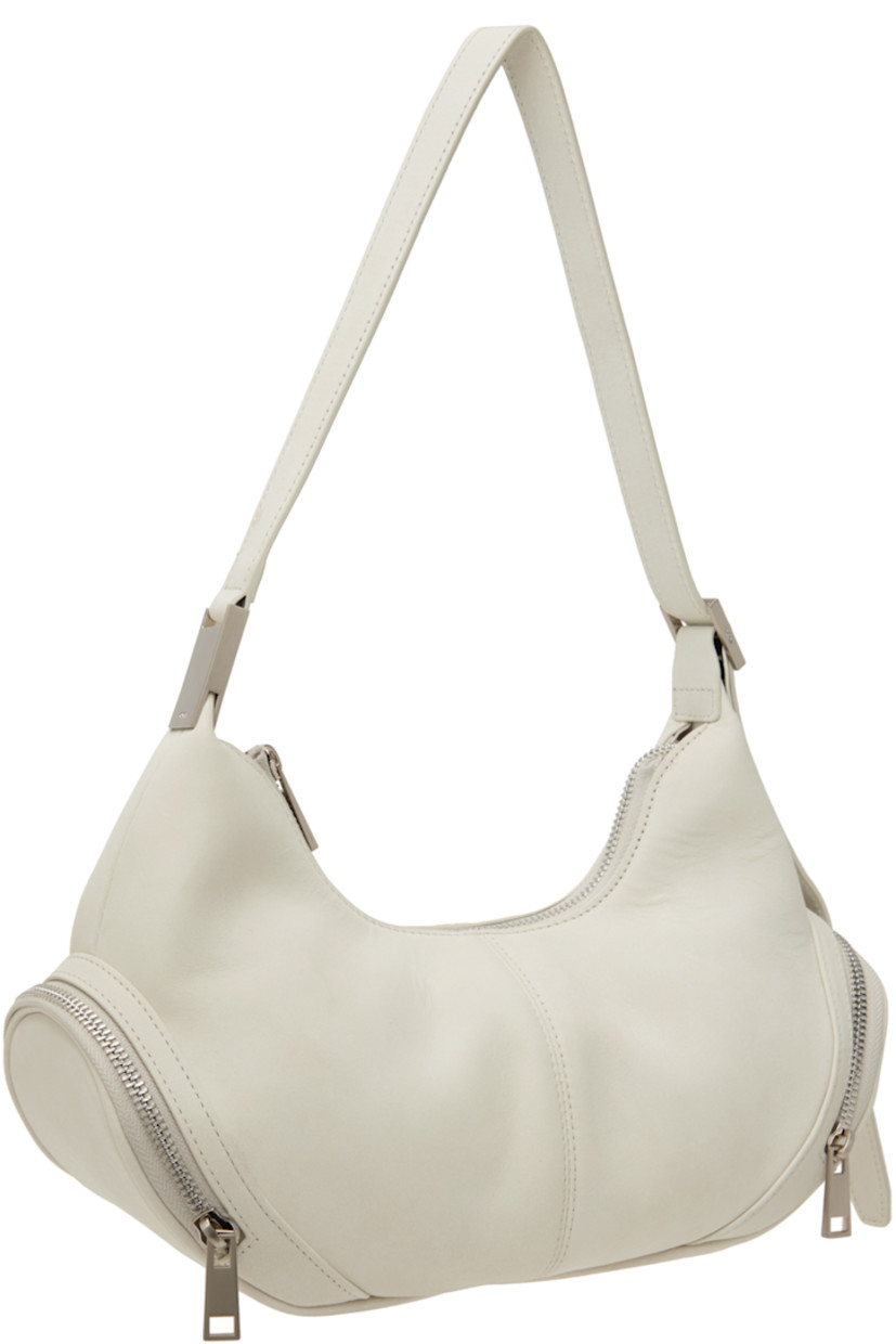 Buffed leather shoulder bag in off-white. 

· Adjustable shoulder strap
· Zip pocket at sides
· Zip closure
· Patch pocket at interior
· Brushed jersey lining
· Logo-engraved silver-tone hardware
· H6" x W12" x D3.5"

Supplier color: Marena cream
