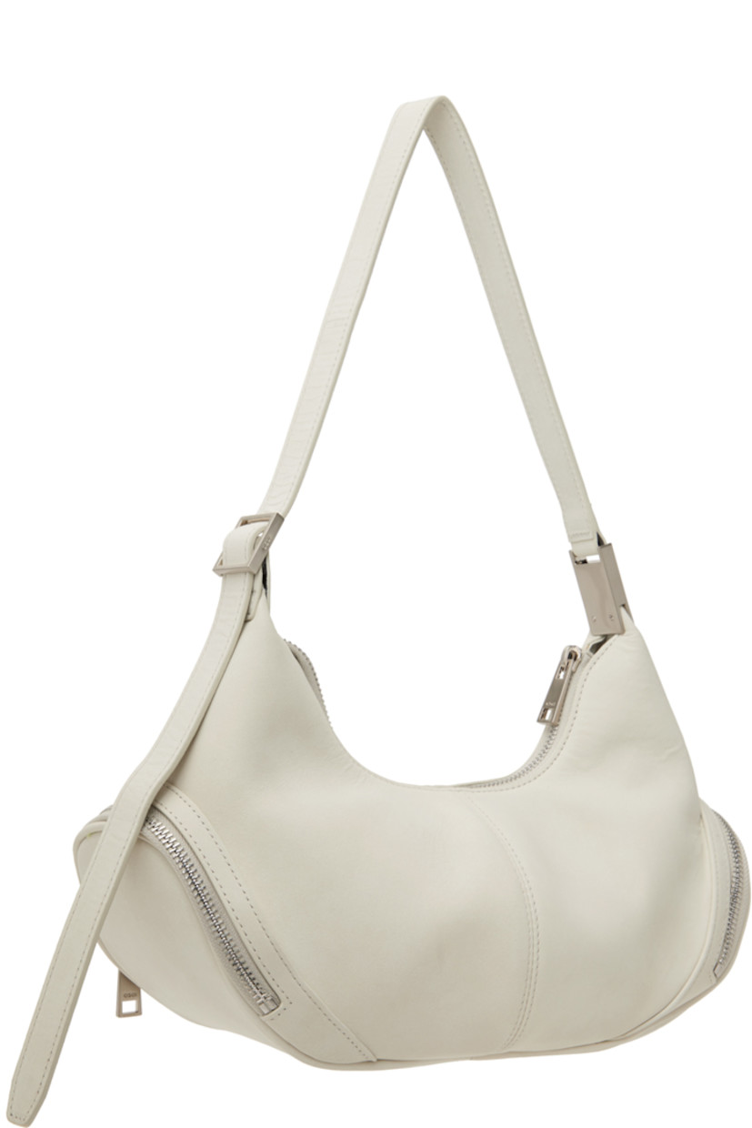 Buffed leather shoulder bag in off-white. 

· Adjustable shoulder strap
· Zip pocket at sides
· Zip closure
· Patch pocket at interior
· Brushed jersey lining
· Logo-engraved silver-tone hardware
· H6" x W12" x D3.5"

Supplier color: Marena cream