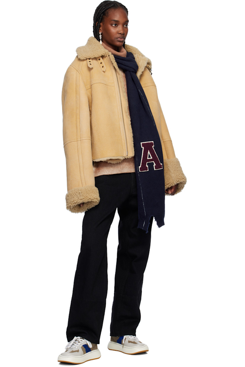 Rectangular knit virgin wool scarf in navy.

· Bouclé logo appliqué at face
· Rib-knit ends
· Distressing at end
· Contrast whipstitching in white
· L78" x W9.5"

Supplier color: Navy/Russet brown