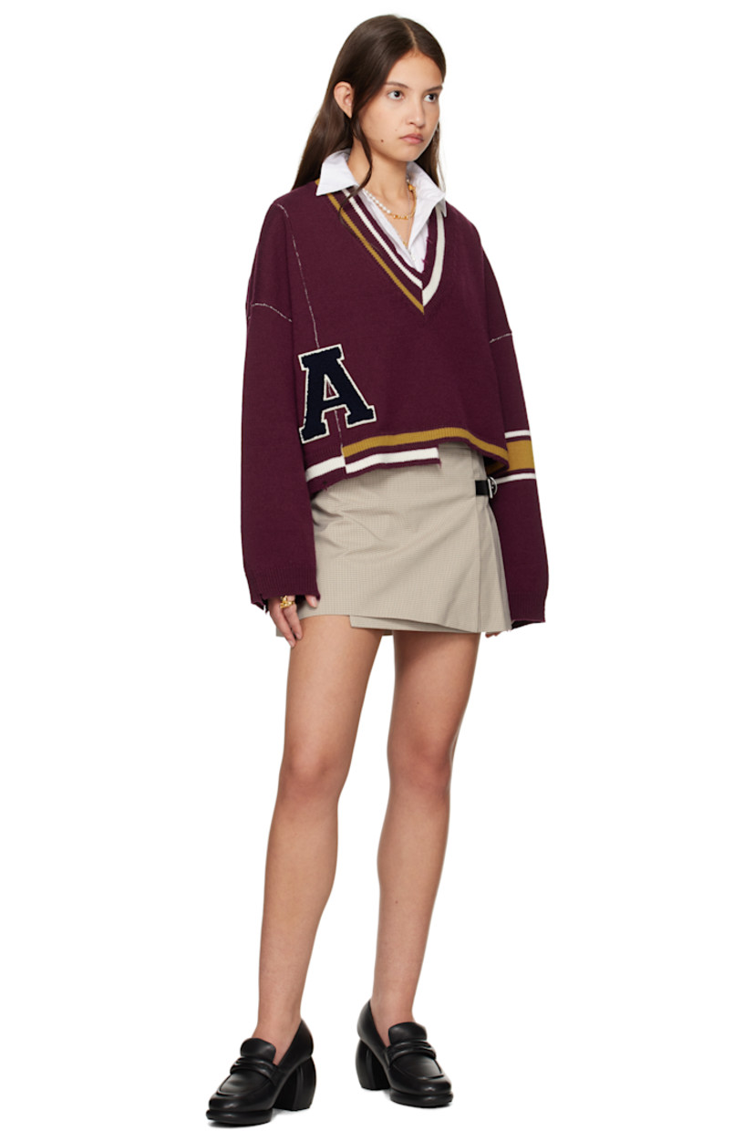 Stretch cotton- and nylon-blend broadcloth miniskirt. Check pattern throughout. 

· Wrap construction
· Integrated pin-buckle fastening at waist
· Box pleats at side and back 
· Full logo-woven viscose twill lining

Supplier color: Light brown