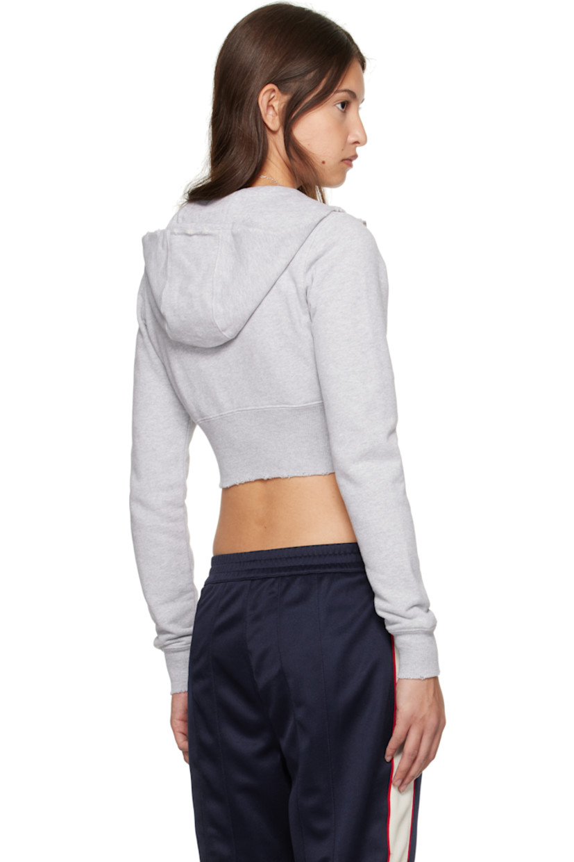Organic cotton French terry hoodie. 

· Distressing at hood, hem, and cuffs
· Zip closure
· Reverse French terry logo appliqué at front
· Rib-knit cropped hem and cuffs

Supplier color: Grey melange