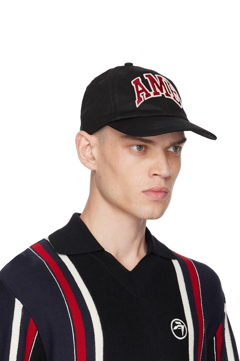 Cotton twill cap in black.

· Embroidered eyelets at crown
· Logo graphic appliqués at face
· Curved brim
· Cinch strap
· Twill browband
· Partially lined

Supplier color: Black