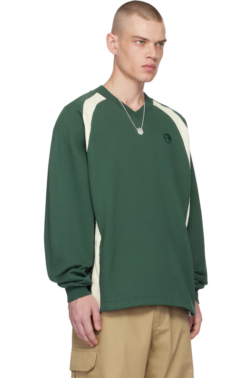 French terry sweatshirt.

· Paneled construction 
· Rib-knit V-neck and cuffs
· Logo embroidered at chest
· Welt pockets
· Raglan sleeves

Supplier color: Green