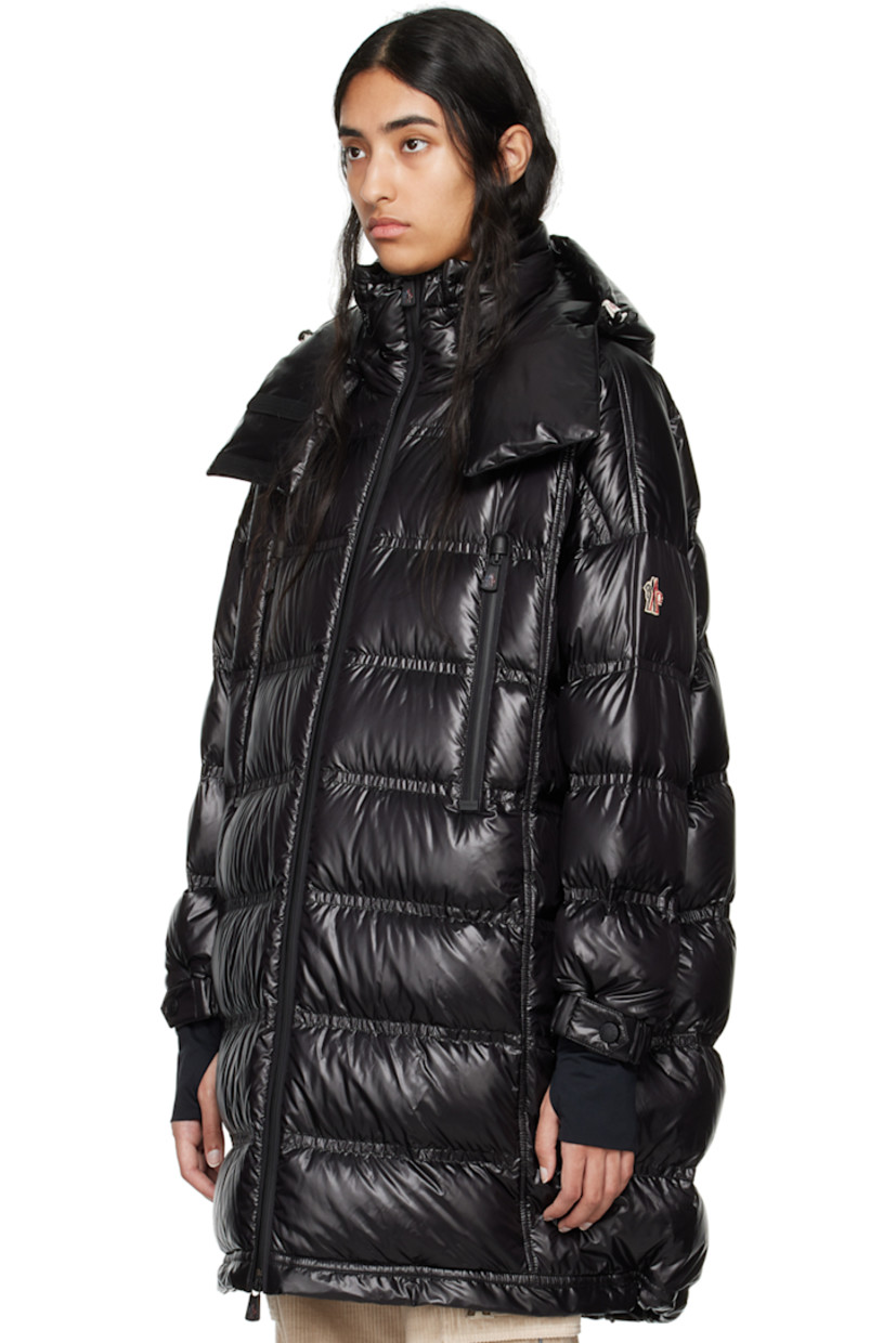 DIST-certified down-filled and quilted nylon laqué coat. Water-repellent, windproof, lightweight, and breathable. 

· Bungee-style drawstring at detachable hood
· Stand collar
· Two-way YKK® AquaGuard® zip closure
· Zip pockets
· Bungee-style drawstring at hem 
· Logo patch at sleeve
· Adjustable press-stud tab at elasticized cuffs
· Thumbhole at inset jersey cuffs
· Zip pocket at interior
· Fully lined 

Supplier color: Black

Fill: 90% goose down, 10% feather.