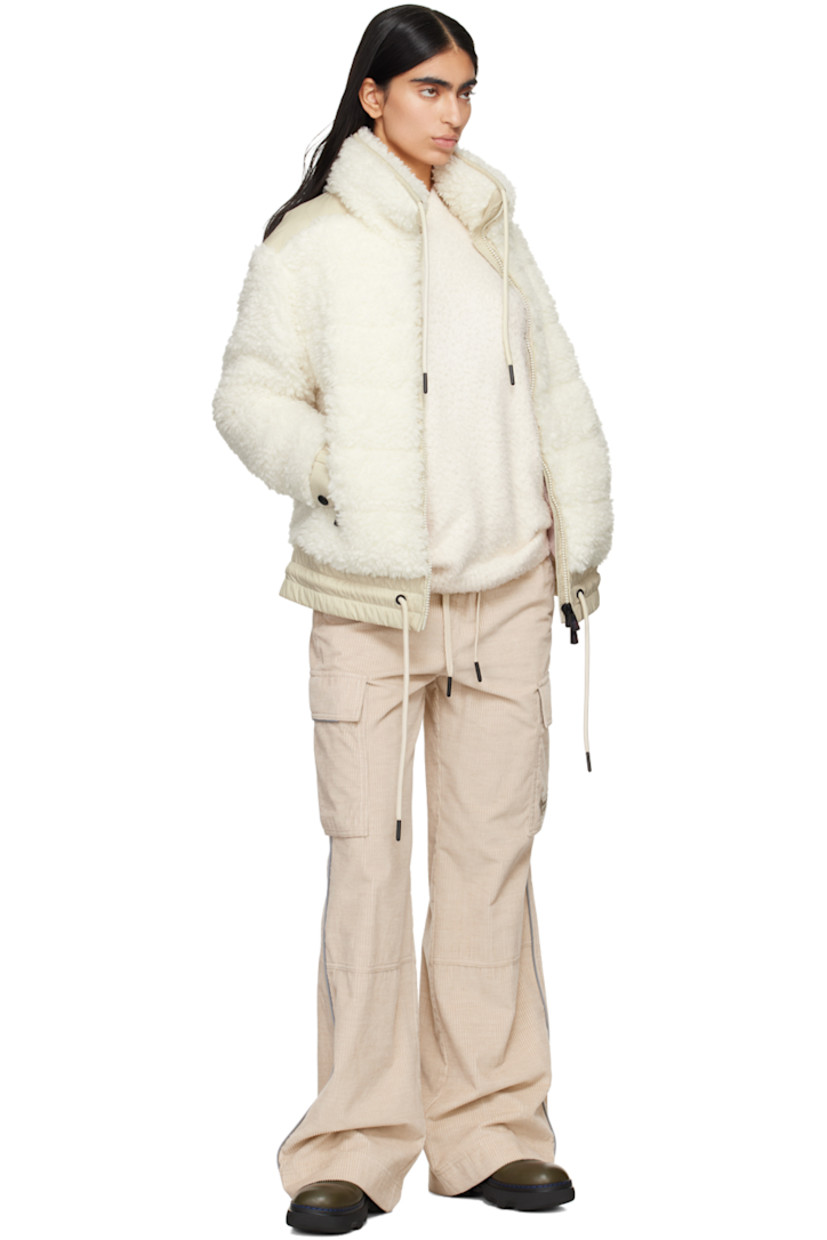 DIST-certified down-filled and quilted faux-shearling jacket.

· Paneled construction
· Drawstring at stand collar and hem
· Zip closure
· Zip pockets
· Elasticized hem 
· Embroidered logo patch at sleeve
· Adjustable press-stud fastening at elasticized cuffs
· Full nylon laqué lining

Supplier color: White 

Fill: 90% goose down, 10% feather.