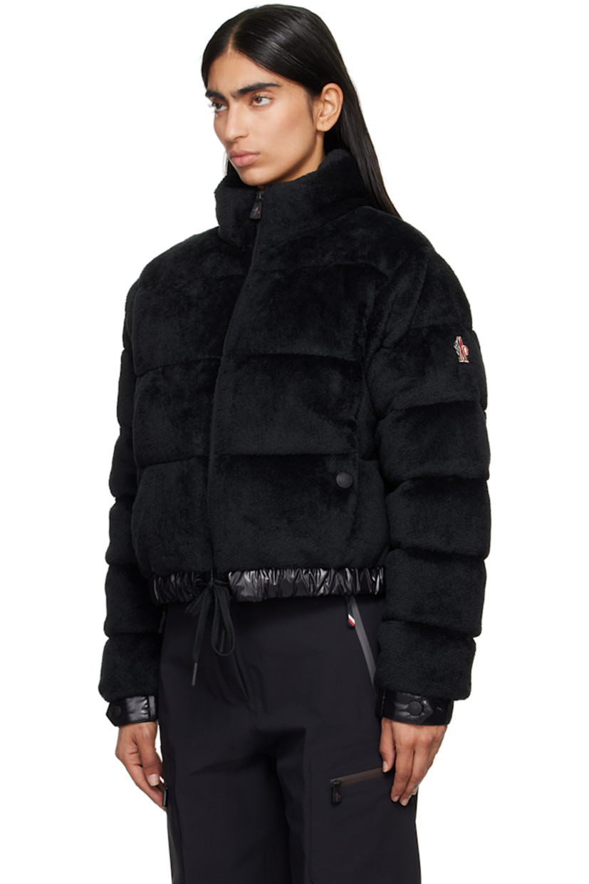 DIST-certified down-filled and quilted stretch faux-fur jacket. Breathable and lightweight. 

· Paneled construction
· Stand collar
· Zip closure
· Welt pockets
· Drawstring at elasticized hem 
· Embroidered logo patch at sleeve
· Adjustable press-stud fastening at elasticized cuffs
· Zip pocket at interior 
· Full nylon laqué lining

Supplier color: Black

Fill: 90% goose down, 10% feather.