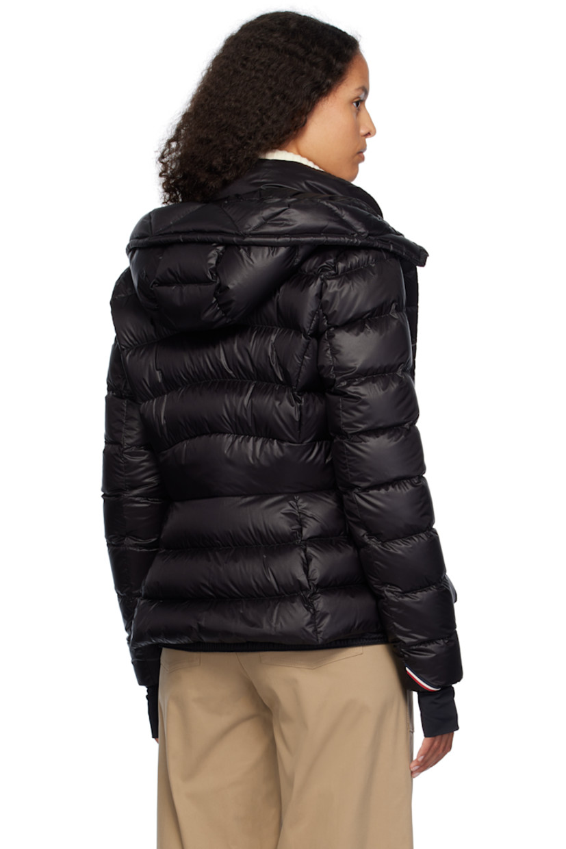 DIST-certified down-filled and quilted nylon satin jacket. 

· Bungee-style drawstring at hood
· Stand collar
· Two-way zip closure with press-stud placket
· Zip pockets
· Embroidered logo patch at sleeve
· Inset jersey cuffs
· Snow skirt with elasticized hem at interior
· Full satin lining

Supplier color: Black

Fill: 90% goose down, 10% feather.