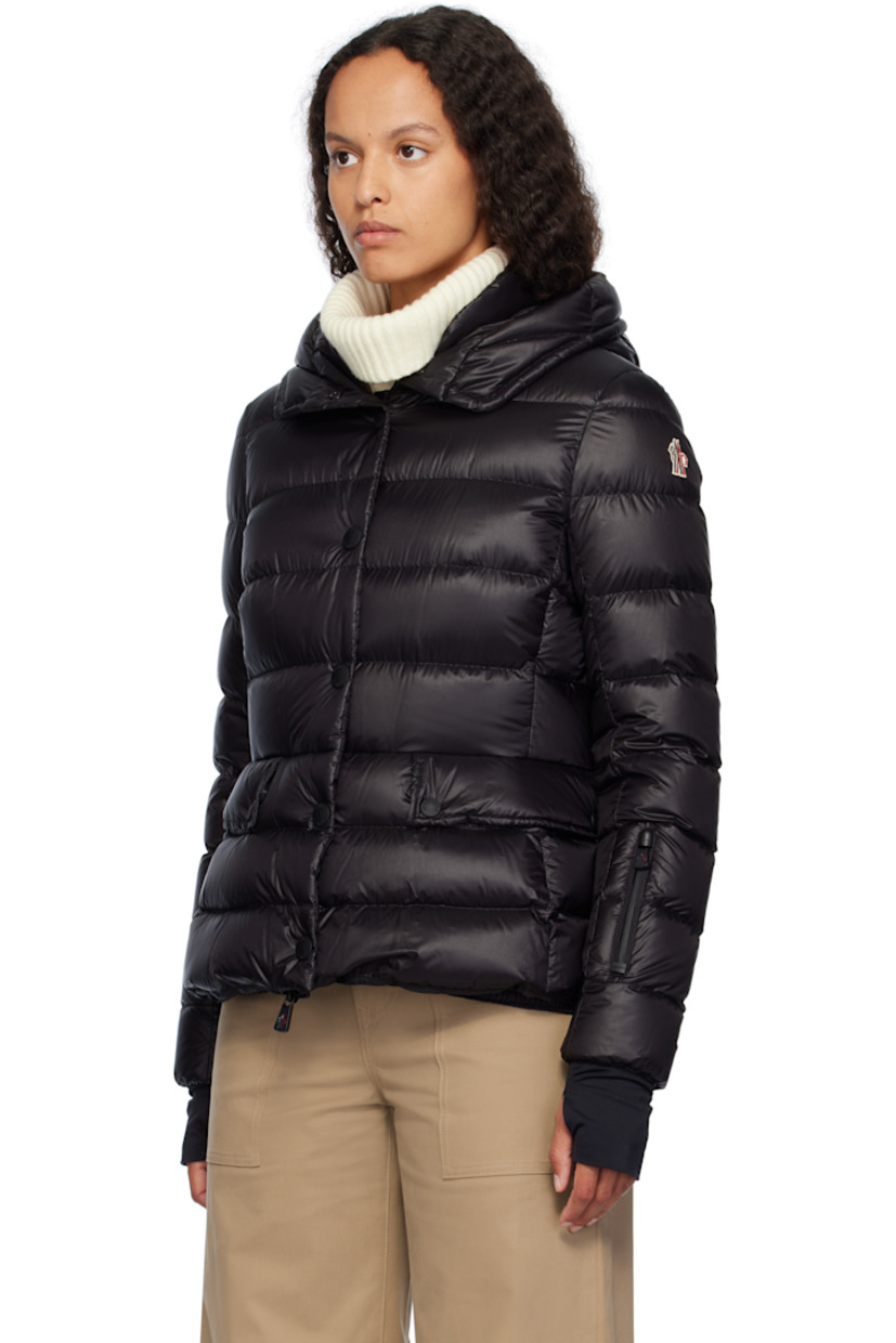 DIST-certified down-filled and quilted nylon satin jacket. 

· Bungee-style drawstring at hood
· Stand collar
· Two-way zip closure with press-stud placket
· Zip pockets
· Embroidered logo patch at sleeve
· Inset jersey cuffs
· Snow skirt with elasticized hem at interior
· Full satin lining

Supplier color: Black

Fill: 90% goose down, 10% feather.