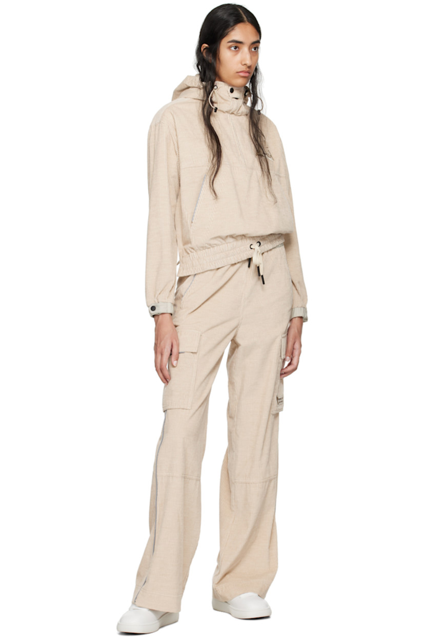 Breathable and lightweight cotton corduroy jacket. Reflective trim throughout.

· Bungee-style drawstring at elasticized hood 
· Stand collar
· Half-zip closure
· Bouclé logo patch at chest
· Kangaroo pocket
· Drawstring at elasticized hem
· Zip vent at side seams
· Adjustable press-stud tab at elasticized cuffs
· Storm flap and logo patch at back 
· Nylon taffeta lining

Supplier color: Pink