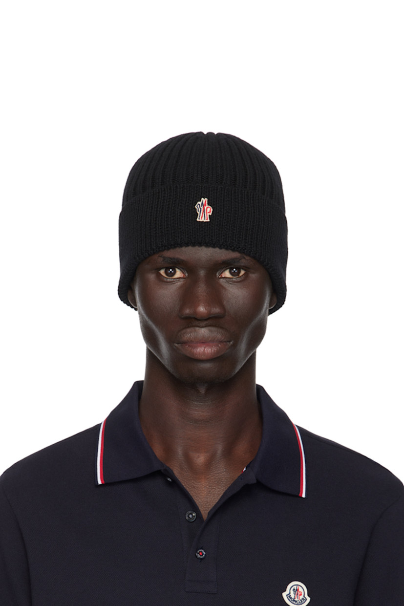 5-gauge rib knit virgin wool beanie in black. Embroidered logo patch at rolled brim.

Part of the Après-Ski collection.

Supplier color: Black