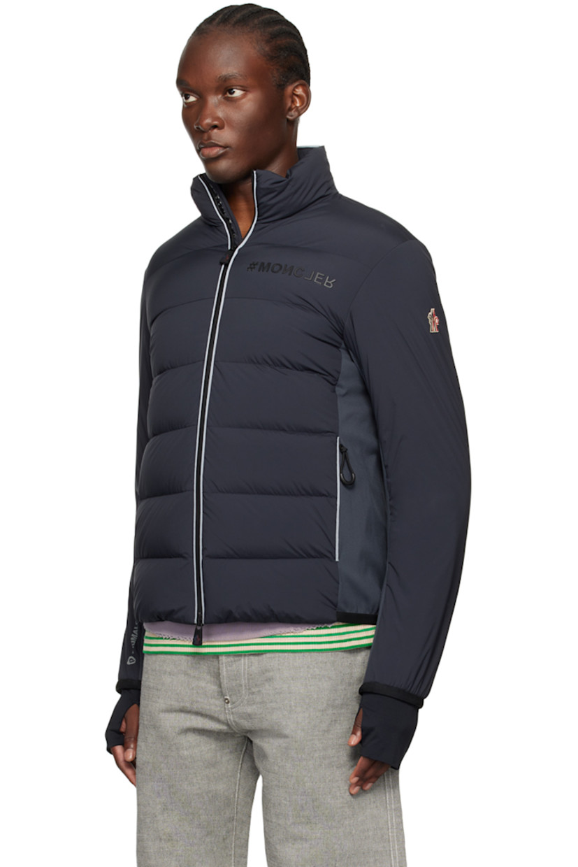 Primaloft®-insulated and DIST-certified down-filled quilted stretch nylon taffeta and stretch nylon interlock jersey jacket. Reflective trim throughout.

· Water-repellent, windproof, lightweight, and breathable
· Paneled construction
· Stand collar
· Two-way zip closure
· Rubberized logo at chest
· Zip pockets
· Elasticized trim at hem and cuffs 
· Embroidered logo patch at sleeve
· Text printed at cuff and back hem
· Thumbhole at inset stretch jersey cuffs
· Zip pocket at interior
· Partial stretch jersey lining
· Logo-engraved black hardware

Supplier color: Grey

Fill 1: 90% goose down, 10% goose feather.