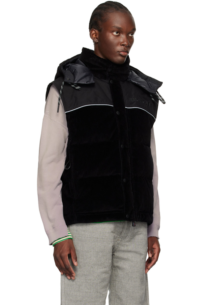 DIST-certified down-filled quilted stretch cotton corduroy jacket. Reflective trim throughout.

· Breathable and lightweight 
· Drawstring at detachable hood
· Funnel neck
· Two-way zip closure with press-stud placket
· Canvas panel at front and back 
· Logo bonded at chest
· Zip pockets
· Bungee-style drawstring at hem
· Logo flag at side seam
· Detachable sleeves
· Embroidered logo patch at sleeve
· Adjustable press-stud tab at elasticized cuffs
· Reflective perforated logo patch at back yoke
· Zip pocket at interior
· Full satin lining
· Logo-engraved black hardware

Supplier color: Black

Fill 1: 90% goose down, 10% goose feather.