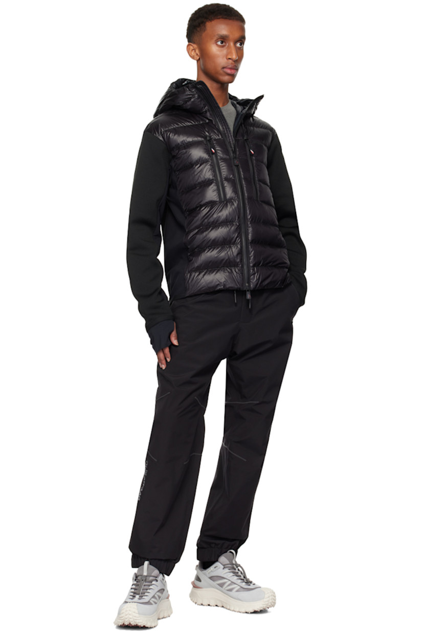 DIST-certified down-filled and quilted nylon laqué, polyester jersey, and knit stretch polyester-blend jacket. Breathable and lightweight.

· Paneled construction
· Webbing trim at hood
· Two-way zip closure
· Zip pockets
· Elasticized curved hem and cuffs
· Embroidered logo patch at sleeve 
· Thumbhole at inset jersey cuffs
· Partial ripstop and fleece lining

Part of the Après-Ski collection.

Supplier color: Black

Fill: 90% goose down, 10% feather.