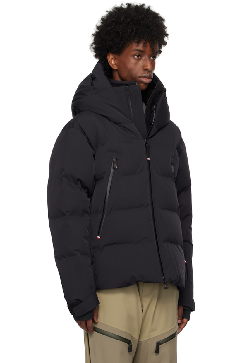 Down-filled and quilted 2L stretch nylon twill jacket. Water-repellent, windproof, lightweight, and breathable.

· Bungee-style drawstring at hood
· Stand collar
· Two-way zip closure
· Zip pockets
· Concealed bungee-style drawstring at hem
· Embroidered logo patch at sleeve
· Velcro strap at cuffs
· Thumbhole at inset jersey cuffs
· Zip pocket and powder skirt at interior
· Nylon satin lining
· YKK® Aquaguard® hardware

Supplier color: Navy blue

Fill: 90% goose down, 10% feathers.