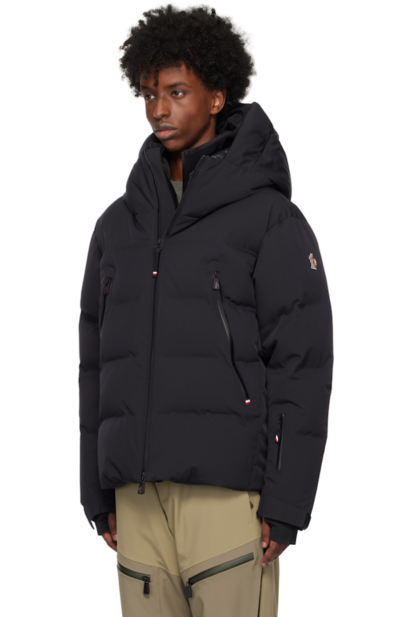 Down-filled and quilted 2L stretch nylon twill jacket. Water-repellent, windproof, lightweight, and breathable.

· Bungee-style drawstring at hood
· Stand collar
· Two-way zip closure
· Zip pockets
· Concealed bungee-style drawstring at hem
· Embroidered logo patch at sleeve
· Velcro strap at cuffs
· Thumbhole at inset jersey cuffs
· Zip pocket and powder skirt at interior
· Nylon satin lining
· YKK® Aquaguard® hardware

Supplier color: Navy blue

Fill: 90% goose down, 10% feathers.