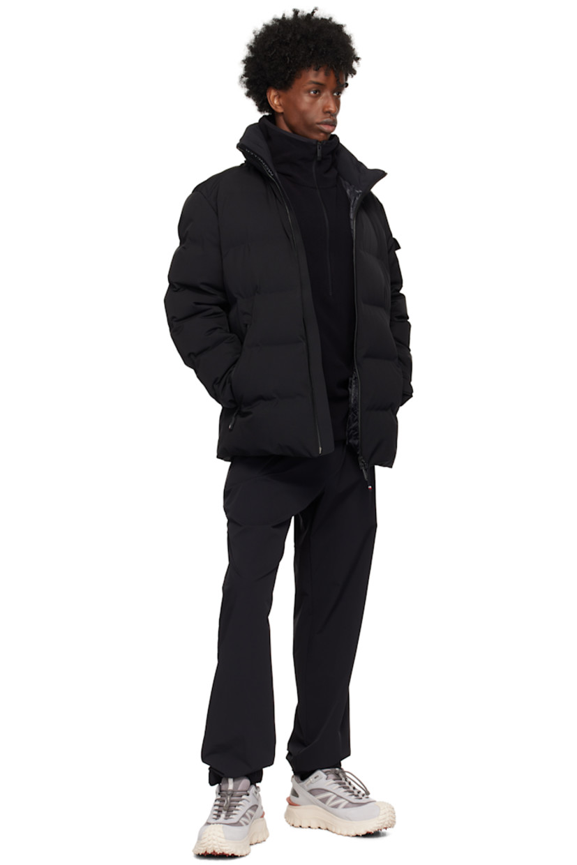 Down-filled and quilted 2L stretch nylon twill jacket. Water-repellent, windproof, lightweight, and breathable.

· Detachable hood
· Bungee-style drawstring and press-stud fastening at hood
· Stand collar
· Two-way zip closure
· Zip pockets
· Bungee-style drawstring at hem
· Embroidered logo patch and flap pocket at sleeve
· Velcro strap at cuffs
· Thumbhole at inset jersey cuffs
· Zip pocket and powder skirt at interior
· Nylon satin lining
· YKK® Aquaguard® hardware

Supplier color: Black

Fill: 90% goose down, 10% feathers.