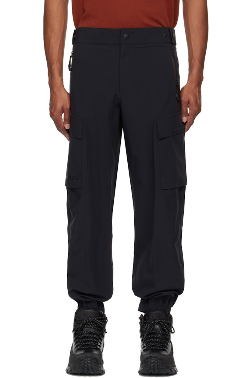 Plain-woven stretch nylon cargo pants. Lightweight, breathable, windproof, and waterproof.

· Adjustable press-stud tabs at partially elasticized waistband
· Two-pocket styling
· Zip-fly
· Creased legs
· Elasticized cuffs
· Cargo pocket and darts at outseams
· Rubberized logo appliqué at pocket
· Reflective logo printed at back waist

Part of the Day-Namic collection.

Supplier color: Black