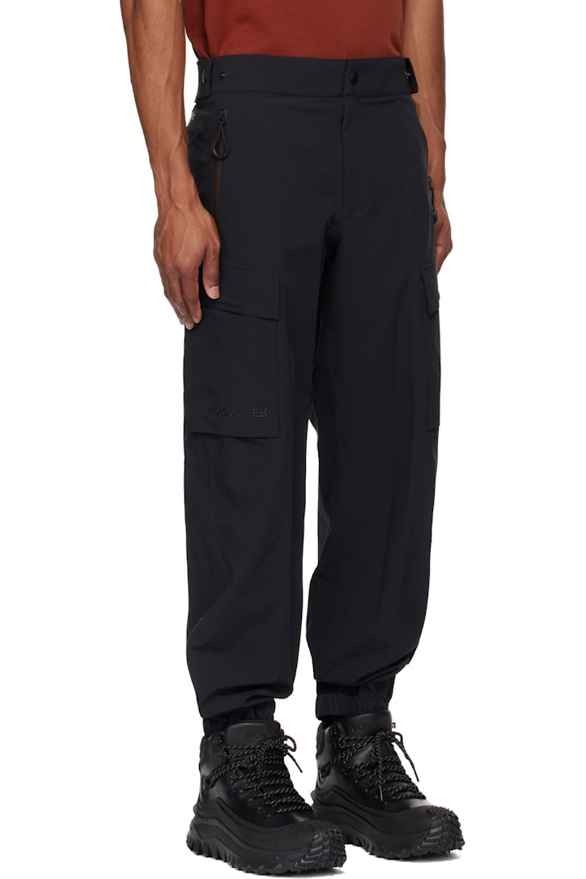 Plain-woven stretch nylon cargo pants. Lightweight, breathable, windproof, and waterproof.

· Adjustable press-stud tabs at partially elasticized waistband
· Two-pocket styling
· Zip-fly
· Creased legs
· Elasticized cuffs
· Cargo pocket and darts at outseams
· Rubberized logo appliqué at pocket
· Reflective logo printed at back waist

Part of the Day-Namic collection.

Supplier color: Black