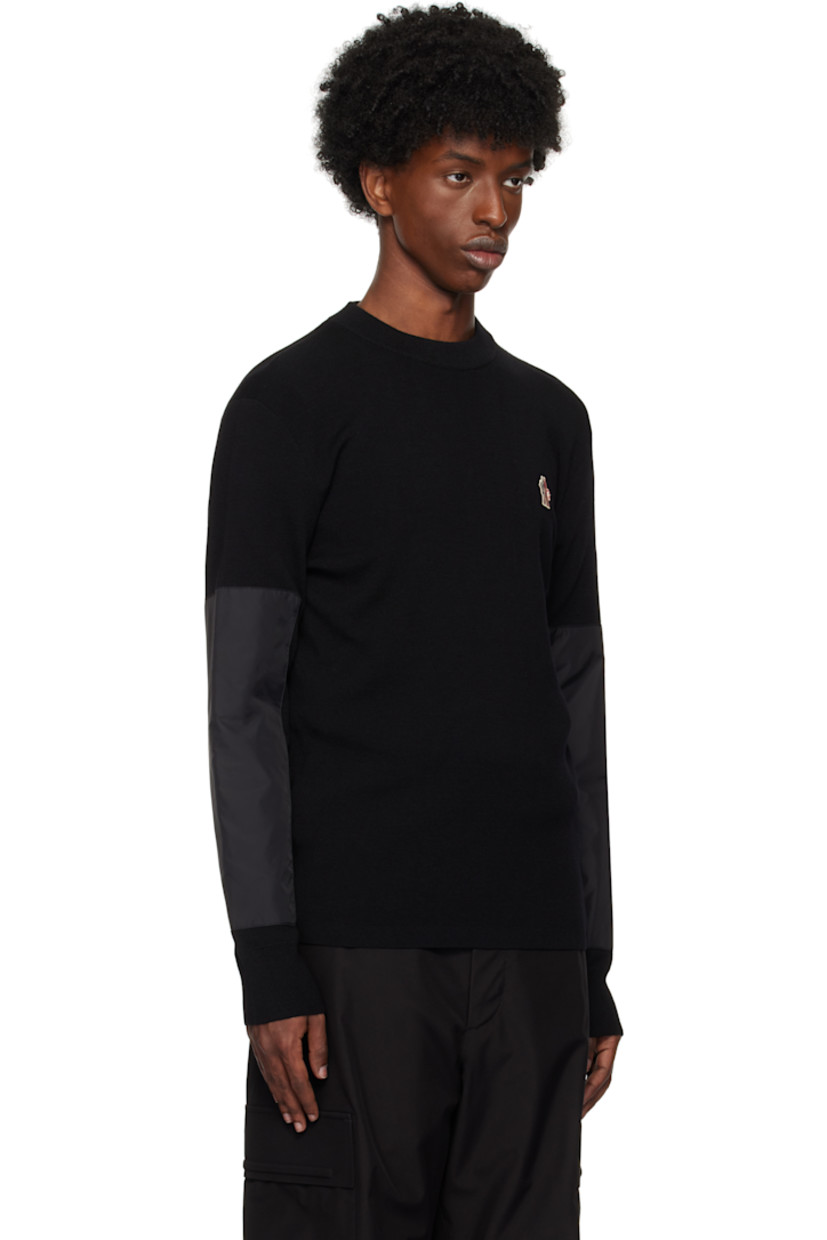 Breathable and insulated lightweight knit wool-blend sweater. 

· Rib-knit crewneck and cuffs
· Logo embroidered at chest
· Nylon taffeta panel and zip pocket at sleeve
· Jacquard tricolor logo at back collar
· Padded nylon taffeta panel at back

Supplier color: Black