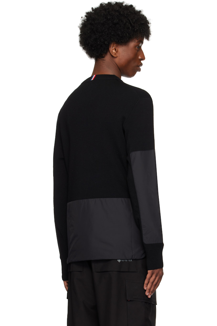 Breathable and insulated lightweight knit wool-blend sweater. 

· Rib-knit crewneck and cuffs
· Logo embroidered at chest
· Nylon taffeta panel and zip pocket at sleeve
· Jacquard tricolor logo at back collar
· Padded nylon taffeta panel at back

Supplier color: Black