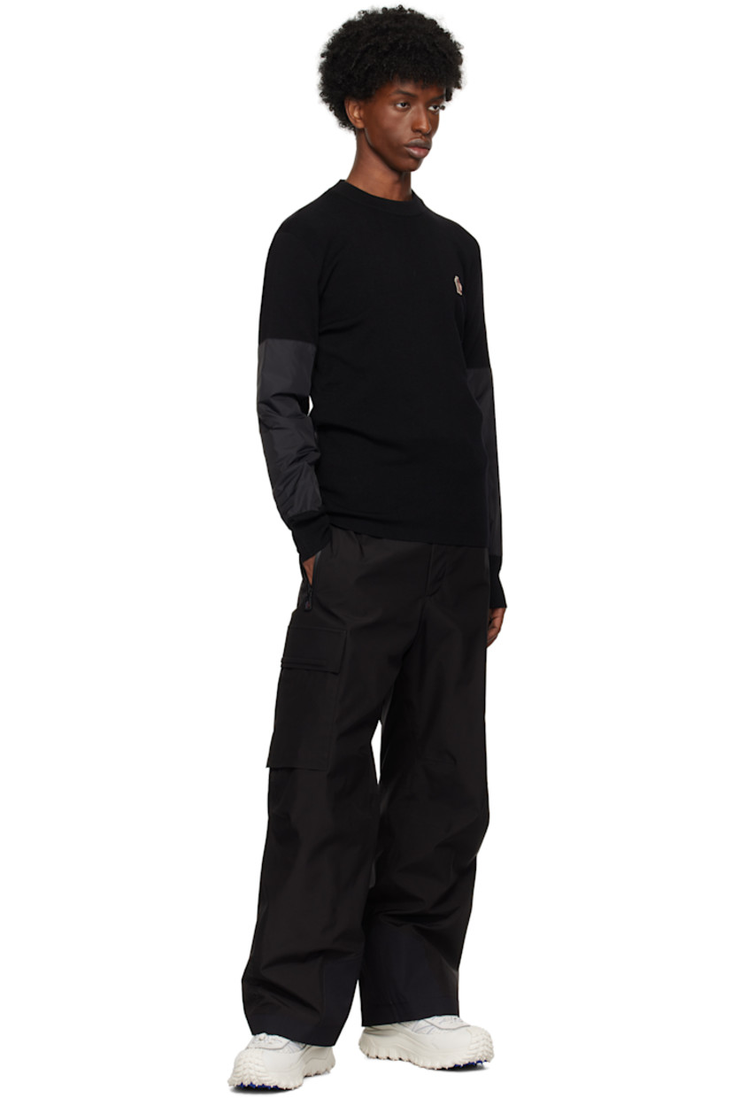 Breathable and insulated lightweight knit wool-blend sweater. 

· Rib-knit crewneck and cuffs
· Logo embroidered at chest
· Nylon taffeta panel and zip pocket at sleeve
· Jacquard tricolor logo at back collar
· Padded nylon taffeta panel at back

Supplier color: Black