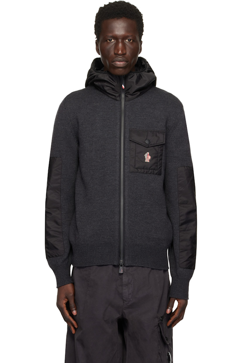 5-gauge knit virgin wool-blend hoodie. Padded water-repellent nylon canvas trim throughout. 

· Paneled construction
· Elasticized trim at hood
· Funnel neck
· Taped two-way zip closure
· Logo patch at flap pocket
· Rib-knit hem and cuffs

Supplier color: Grey