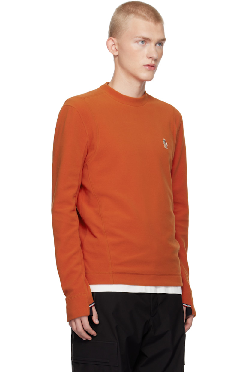 Insulated stretch polyester fleece sweatshirt. Windproof, water-repellent, breathable, and lightweight.

· Crewneck
· Embroidered logo patch at chest
· Thumbhole at cuffs

Supplier color: Orange