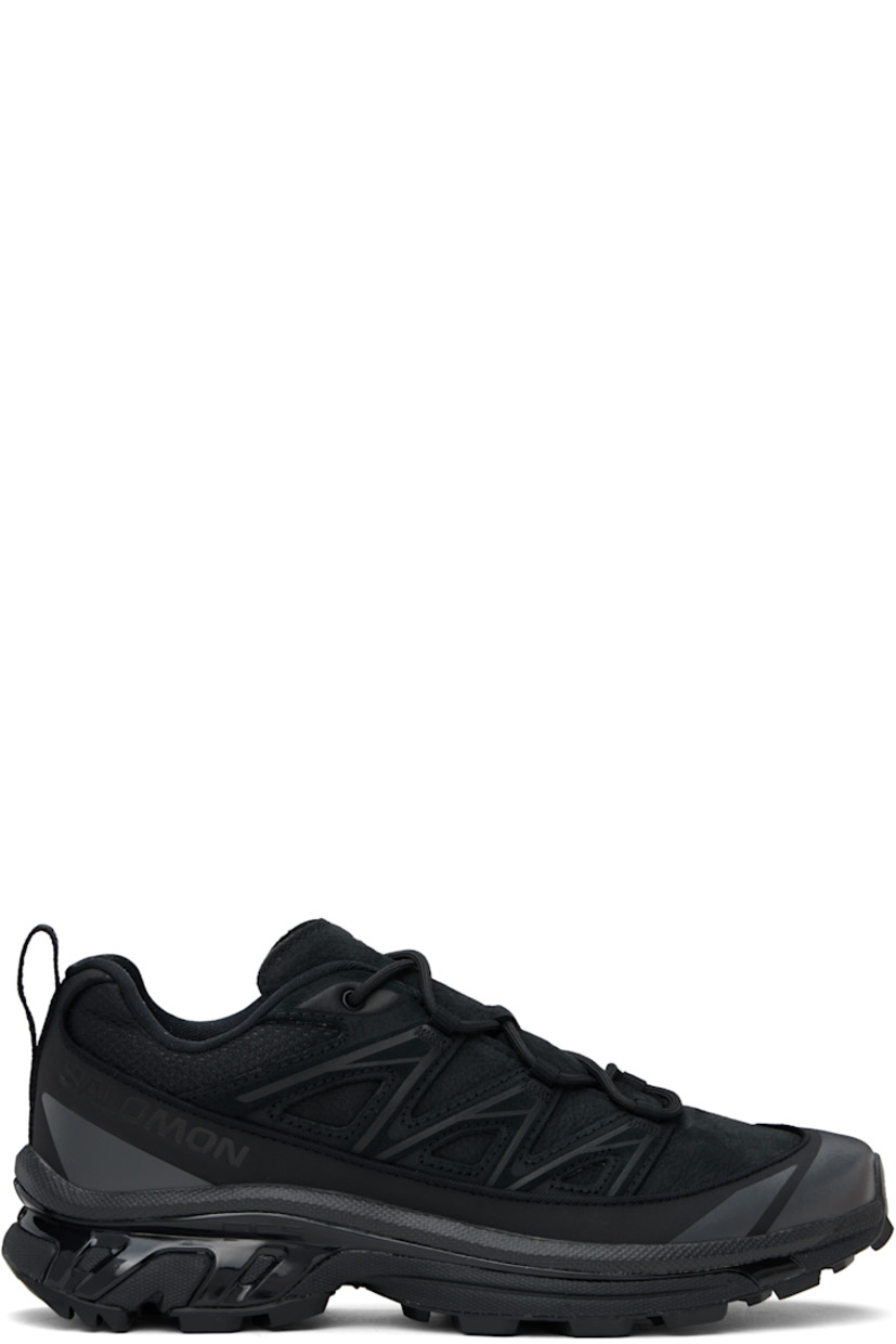 Low-top grained leather, mesh, and suede sneakers in black.

· SensiFit™ overlay and reflective trim throughout
· Lace-up closure
· Padded tongue and collar
· Logo embossed at outer side
· Webbing pull-loop at heel tab
· Jersey lining
· Molded OrthoLite® footbed
· Agile Chassis™ System rubber midsole
· Lugged Mud Contagrip® rubber sole

Supplier color: Black/Black/Asphalt