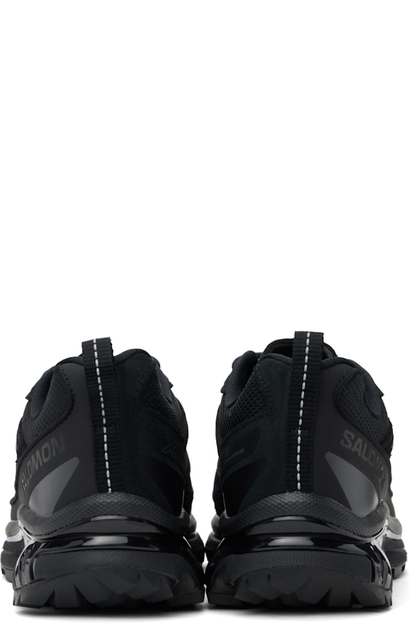 Low-top grained leather, mesh, and suede sneakers in black.

· SensiFit™ overlay and reflective trim throughout
· Lace-up closure
· Padded tongue and collar
· Logo embossed at outer side
· Webbing pull-loop at heel tab
· Jersey lining
· Molded OrthoLite® footbed
· Agile Chassis™ System rubber midsole
· Lugged Mud Contagrip® rubber sole

Supplier color: Black/Black/Asphalt