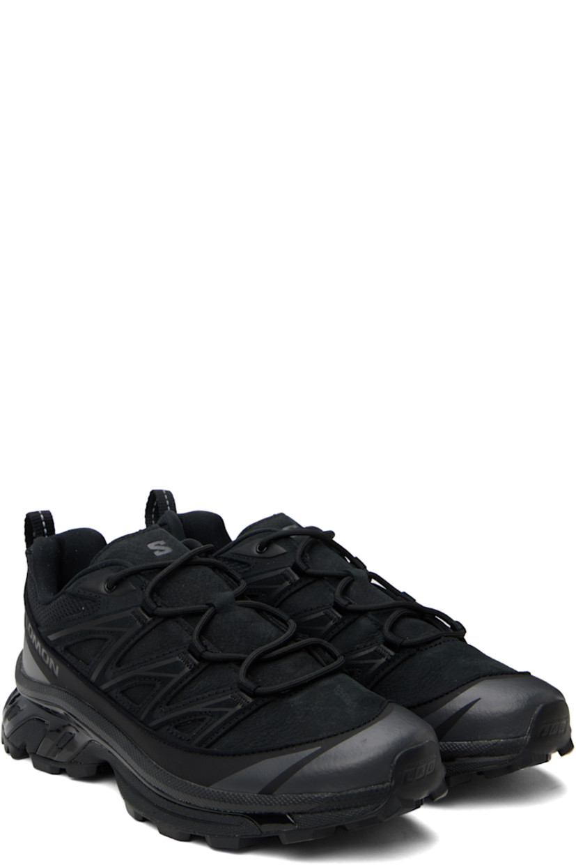 Low-top grained leather, mesh, and suede sneakers in black.

· SensiFit™ overlay and reflective trim throughout
· Lace-up closure
· Padded tongue and collar
· Logo embossed at outer side
· Webbing pull-loop at heel tab
· Jersey lining
· Molded OrthoLite® footbed
· Agile Chassis™ System rubber midsole
· Lugged Mud Contagrip® rubber sole

Supplier color: Black/Black/Asphalt