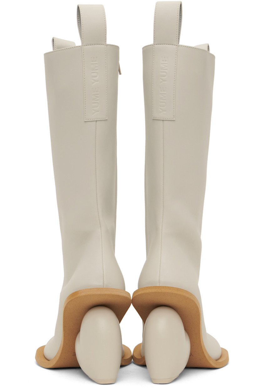 Calf-high buffed faux-leather boots in off-white. 

· Pull-loops at collar
· Zip closure at inner side
· Logo embossed at heel tab
· Sculptural heel with rubber injection
· Foam rubber sole
· Heel: H3.75"

Available exclusively at SSENSE.

Supplier color: Rainday