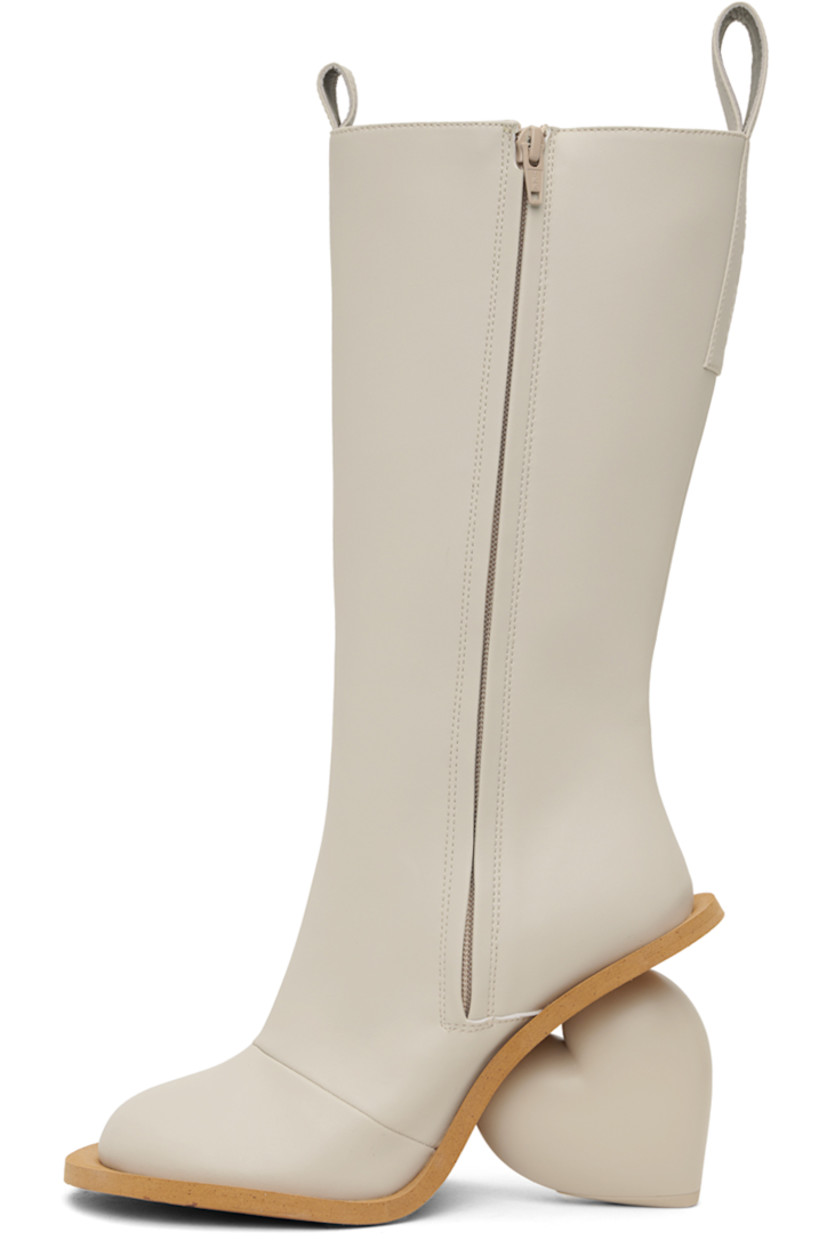 Calf-high buffed faux-leather boots in off-white. 

· Pull-loops at collar
· Zip closure at inner side
· Logo embossed at heel tab
· Sculptural heel with rubber injection
· Foam rubber sole
· Heel: H3.75"

Available exclusively at SSENSE.

Supplier color: Rainday